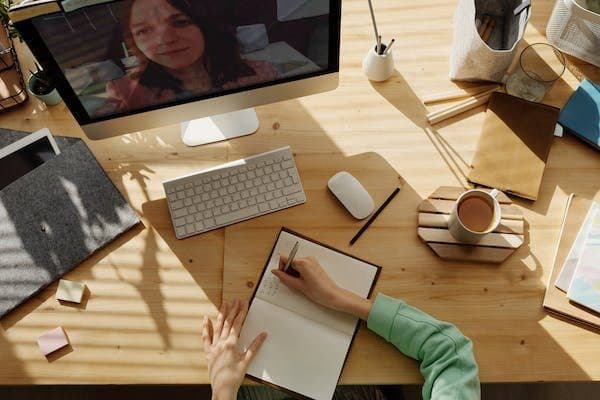 Un bureau : un carnet de notes, un ordinateur, une tasse